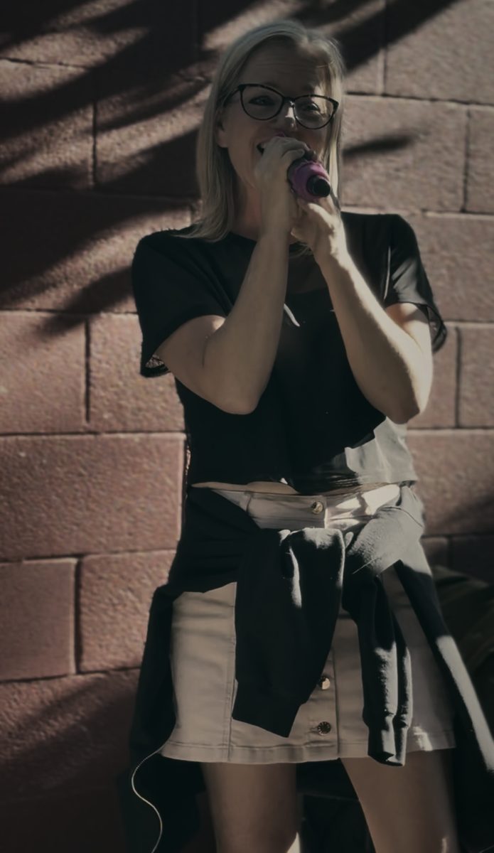 An Echo House night — a singer mid-song at an outdoor set