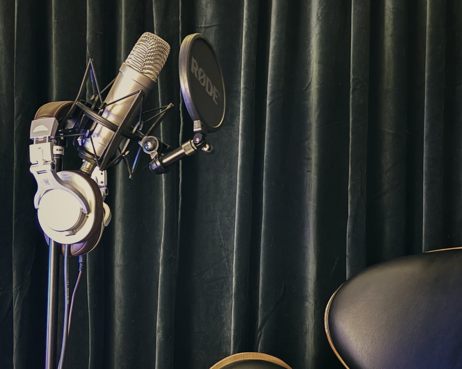 The Echo House Studio — condenser microphone, headphones and pop filter against green velvet